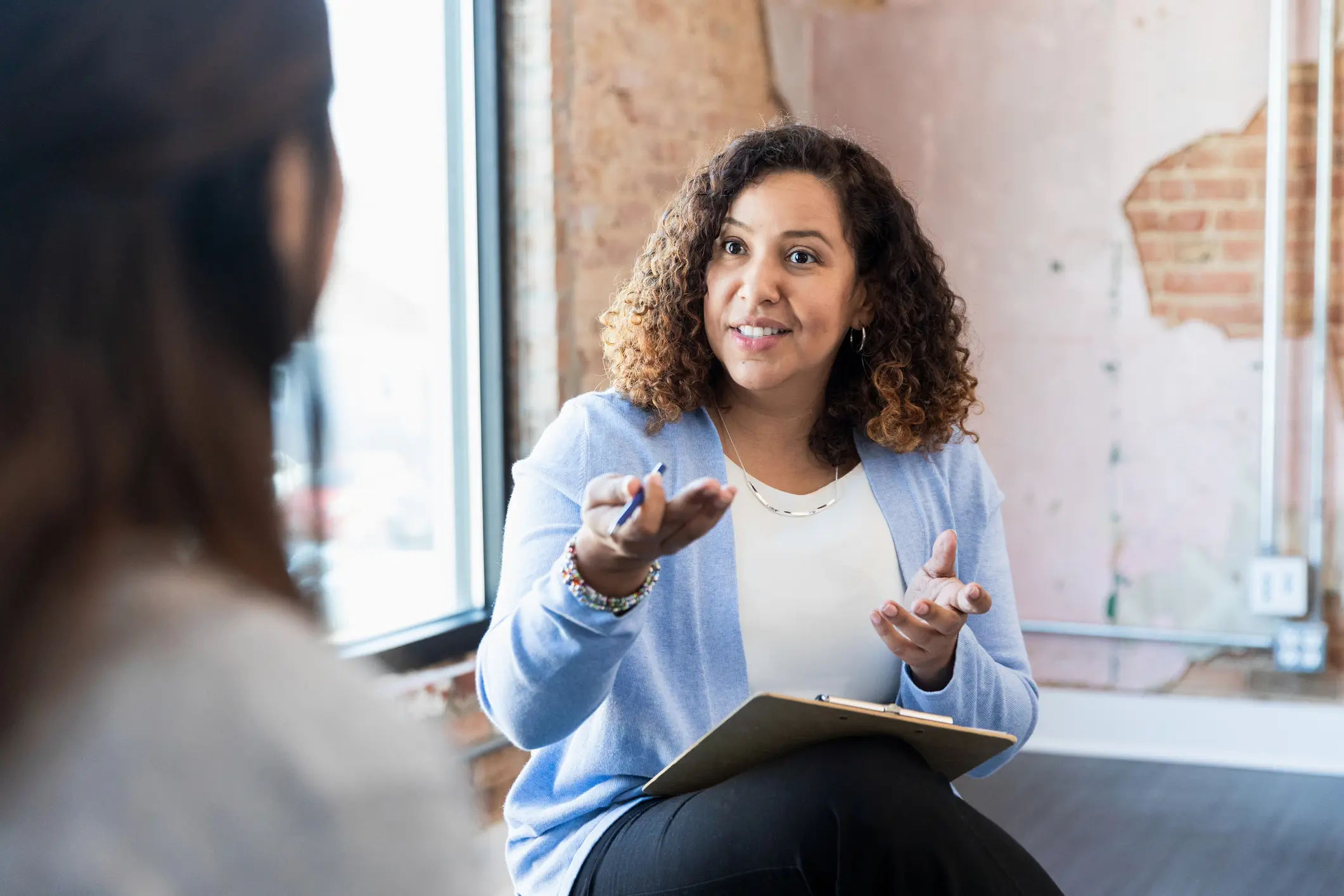 A woman explaining something during a conversation.