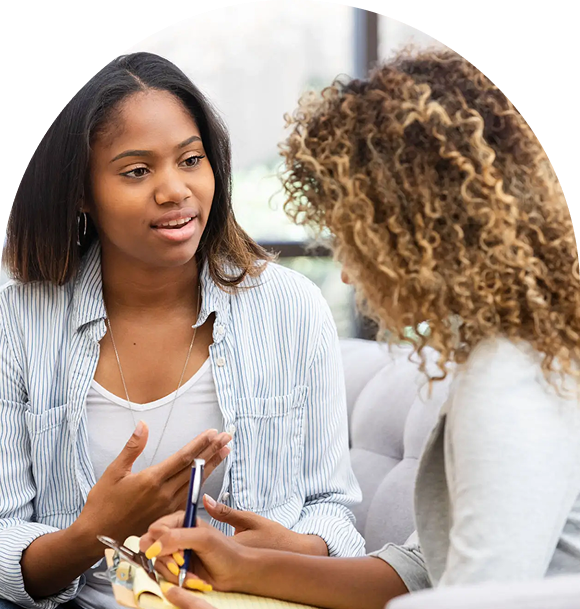 Two women engaged in a thoughtful conversation.