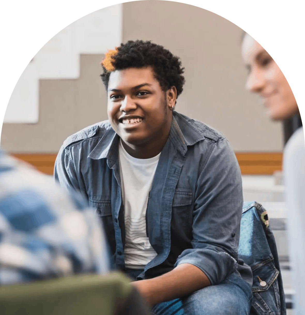 Group of young people having a casual conversation indoors.